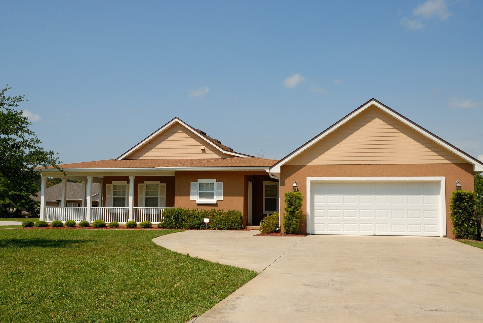 An image of a large tan house, like a rental home you might find when you rent with Florida Management & Consulting Group